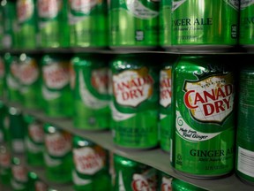 Empty cans of Canada Dry Ginger Ale sit stacked in a warehouse before being filled at the Dr. Pepper Snapple Group Inc. bottling plant in Louisville, Kentucky, U.S., on Tuesday, April 21, 2015. PHOTO BY LUKE SHARRETT/BLOOMBERG.