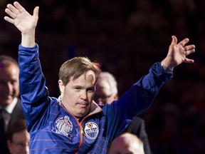 Oilers locker room attendant Joey Moss celebrates during former Oilers coach Glen Sather's banner retirement ceremony held before a NHL game between the Edmonton Oilers and the New York Rangers at Rexall Place on Friday December 11, 2015.