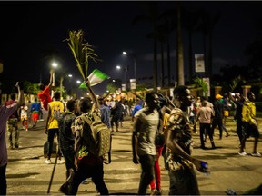 Nigerian protesters are seen in the streets of Alausa Ikeja on October 20, 2020 after the authorities declared an open-ended lockdown in Lagos in the face of spiralling protests. - Several protesters were killed by Nigerian security forces in Lagos on Tuesday, Amnesty International said, after witnesses reported armed men opened fire on demonstrators defying a curfew order. (Photo by Benson Ibeabuchi / AFP)