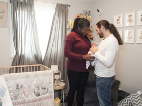 Shakera and Jeremy Paulson cuddle their five-day-old daughter, Marley-Lynn, in their new home by Brookfield Residential in Chappelle Gardens.