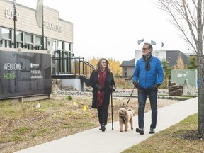 Fred and Carleen Greaves walk with their dog, Chewbacca, at Edge at Larch Park, by Carrington Communities.