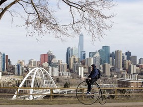 A cyclist rides a penny-farthing bicycle along along Saskatchewan Drive near 106 Street, in Edmonton Monday April 27, 2020.