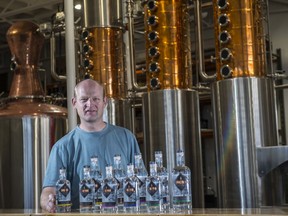 Bryan Anderson at Lone Pine Distillery with bottles of gin and vodka October 6, 2020. The new distillery opened in mid-September. Photo by Shaughn Butts / Postmedia