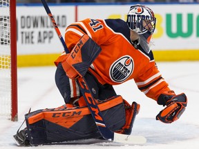 Edmonton Oilers goalie Mike Smith makes a glove save on the Colorado Avalanche during NHL action on Nov. 14, 2019, at Edmonton's Rogers Place.