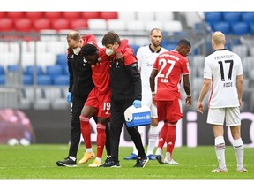 Soccer Football - Bundesliga - Bayern Munich v Eintracht Frankfurt - Allianz Arena, Munich, Germany - October 24, 2020 Bayern Munich's Alphonso Davies goes off injured Pool via REUTERS/Christof Stache DFL regulations prohibit any use of photographs as image sequences and/or quasi-video.