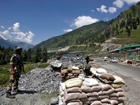India's Border Security Force (BSF) soldiers stand guard at a checkpoint along a highway leading to Ladakh, at Gagangeer in Kashmir's Ganderbal district June 17, 2020.