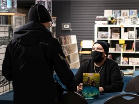 Marvel artist Kyle Charles (right), contributor to Marvel's Indigenous Voices comic, signs autographs at WonderHarbor.