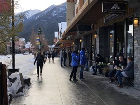 Pedestrians walk down Banff Avenue on Saturday, Nov. 21.