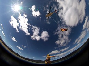 Student rappels from a helicopter