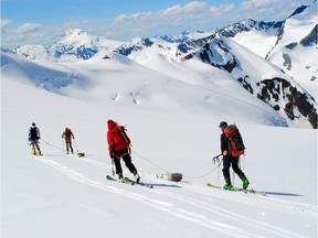 Ben Pelto, Kindy Gosal, Alexandre Bevington and Jesse Milner take radar measurements while towing the radar high on the Nordic Glacier in the southern B.C. Interior. Ice thickness here was around 35 metres. The two sleds containing the transmitter (rear) and receiver/computer (front) must be kept in a straight line, thus the team members at the back keep the rear sled in line.