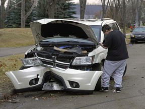 Drew Dixon records images of his mother-in-law's vehicle on 38 Avenue near 55 Street on Thursday morning, November 5, 2020.