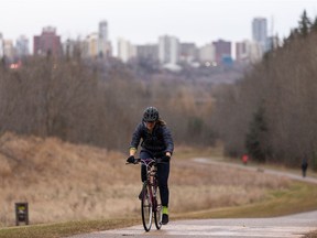 A cyclist rides in MacKinnon Ravine Park as it rains on a fall day in Edmonton, on Thursday, Nov. 5, 2020.
