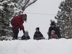 Jaydan Heath,7, (left) Magnus Klostergaard, 6, (middle) and his sister Freya,5, (right) enjoy the fresh Snow at Mike Finland Park on Saturday, Nov. 7, 2020 in Edmonton.