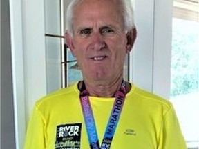 Sporting the marathon T-shirt and medal he won by running the Belfast Marathon virtually is Ken Davison, 75. He hopes a covid-19 vaccine will be found soon and he won't have to run the Aug.  22 Edmonton Marathon virtually. He also ran the recent Dublin Marathon virtually and is waiting for his T-shirt and medal to arrive in the mail.