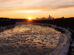The sun sets over the North Saskatchewan River as ice forms into frazil pans in Edmonton, on Saturday, Nov. 14, 2020.