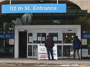 Signs are posted at the  University of Alberta Hospital entrance as Alberta Health Services has again limited visitation rules to a maximum of two designated support people due to COVID-19 on Tuesday, Nov. 17, 2020.