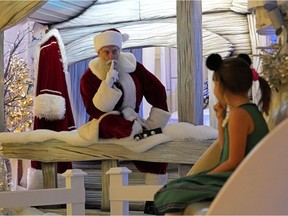 Santa Claus met with Emily Arndt, six, at West Edmonton Mall on Wednesday, Nov. 18, 2020, but kept a physical distance due to the COVID-19 pandemic. Santa will be at the mall until Dec. 24 and is available by appointment only.