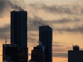 The cold is seen in the steam rising from downtown office buildings, seen from Forest Heights Park in Edmonton, on Thursday, Nov. 19, 2020.