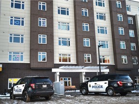 Police vehicles parked outfront as the homicide section is investigating a suspicious death at Melcor YMCA Village, 10350 95 St. that occurred on Friday night in Edmonton, November 21, 2020. Ed Kaiser/Postmedia