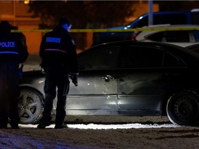 Edmonton Police Service officers investigate a shooting involving two victims at the Woodridge Condominiums near 121 Street and 146 Avenue in Edmonton, on Tuesday, Nov. 24, 2020. Edmonton police had responded to 152 shootings as of Dec. 14, 119 of which resulted in injury or death.