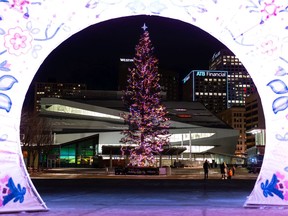 Edmontonians visit Transformation: Promise and Wisdom by artists Sharon Rose Kootenay and Jason Symington from The Works Art & Design Festival and the giant holiday tree in Churchill Square during Downtown Holiday Light Up in Edmonton, on Friday, Nov. 27, 2020. The event is presented by the Downtown Business Association.