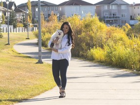 Mawie Castro and her dog, Theo, take a stroll in their new community of Crystallina Nera.