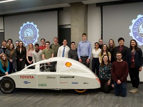 The University of Alberta engineering students who are part of the EcoCar team stand around their  named EcoCar named Kate. Image supplied