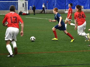 The Edmonton Police Service Blues (red) faced the Edmonton Scottish United U-13 team in the annual Woodall Cup at the Edmonton Soccer Dome on November 29, 2018.