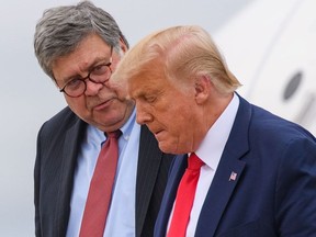 In this file photo taken on September 1, 2020 US President Donald Trump (R) and US Attorney General William Barr step off Air Force One upon arrival at Andrews Air Force Base in Maryland.