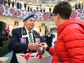 On this Remembrance Day, safely talk to a man or woman in uniform, says columnist. You never know what stories you'll hear. In this file photo from 2016, Skip Saunders continues his tradition of handing out poppies at Chinook Centre.