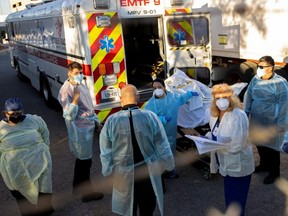 Bodies are moved to refrigerated trailers, deployed during a surge of COVID-19 deaths, outside the County of El Paso Medical Examiners Office in El Paso, Texas, Monday, Nov. 16, 2020.