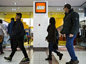 People walk past the Lego Store during Boxing Day at Southgate Centre in Edmonton, Alta., on Friday, Dec. 26, 2014.