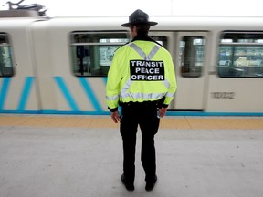 A transit peace officer watches an LRT train pull out of the Century Park South LRT station, file photo.