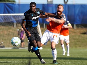 FC Edmonton defender Kareem Moses, left, fends off Forge FC midfielder Anthony Novak in Canadian Premier League Island Games play in Charlottetown, P.E.I., on Aug. 16, 2020.