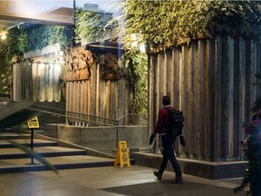 Partially bare cement pillars are now visible at the Federal Building as removal of the living wall of greenery  has begun, in Edmonton Tuesday Nov. 24, 2020. The multi-level plant display in the building's atrium, costs $70,000 a year to maintain.