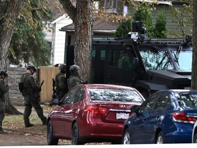 The police Tactical Unit prepare to enter the house after a shooting occurred at 12952 117 St. in north Edmonton, November 3, 2020.