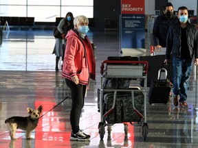 Travellers move through the Calgary International Airport on Thursday, Nov. 26, 2020.
