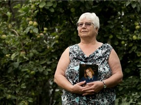 Kathy King holds a photo of her daughter Cara King in Edmonton on Aug. 15, 2018.