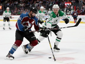 Nazem Kadri (91) of the Colorado Avalanche advances the puck against Thomas Harley (55) of the Dallas Stars at the Pepsi Center on Sept. 19, 2019.