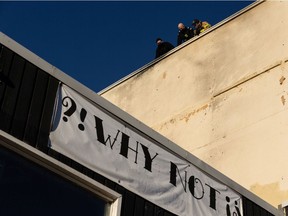 Edmonton Fire Rescue Services firefighters investigate a fire at Why Not Cafe and Bar above the Strath Moto shop at 8534 109 St. in Edmonton on Sunday, Dec. 6, 2020.