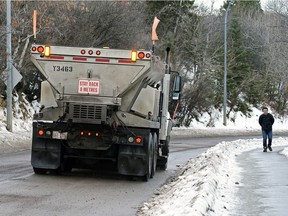 A truck applies sand to Emily Murphy Park Road after an overnight rainfall created icy road conditions in Edmonton on Tuesday, Dec. 8, 2020.
