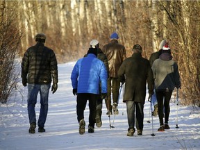 A group of friends take a walk at Hawrelak Park in Edmonton on Wednesday, Dec. 9, 2020.