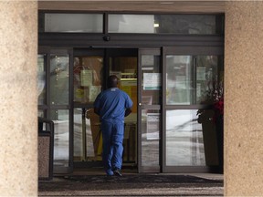 A medical worker enters Capital Care Lynnwood in west Edmonton on Dec. 16, 2020. The facility is the location of a severe COVID-19 outbreak.