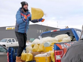 Jay Downton,  a, co-owner of Oodle Noodle packing a truck with food to donate. Oodle Noodle is delivering 700 meals of locally made noodles, sauces, vegetables and protein, to help feed Edmonton's most vulnerable this holiday season. The meals will be served at the Edmonton Convention Centre Shelter.