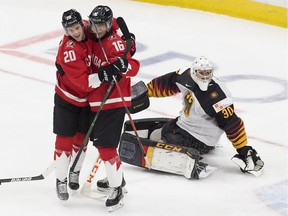 Canada's Dawson Mercer (20) and Ryan Suzuki (16) celebrate a goal against Germany during second period IIHF World Junior Hockey Championship action on Saturday, Dec. 26, 2020 in Edmonton.