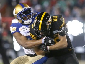 Hamiton receiver Jaelin Acklin is tackled by a Blue Bomber during the 107th Grey Cup in Calgary last November. The next CFL season will be drastically different considering the financial strain brought on by COVID-19.