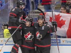 Canada's Connor McMichael, centre, celebrates with teammates Liam Foudy, left, and Joe Veleno, right, after scoring the second goal against Slovakia during second period quarterfinal action at the World Junior Hockey Championships on Thursday, January 2, 2020 in Ostrava, Czech Republic.