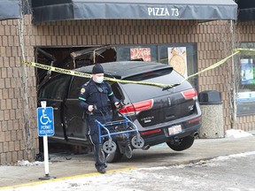 A collision between two SUVs in a strip mall parking lot in Wolf Willow sent one vehicle careening into the front window of a pizza shop.