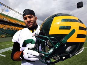 Calvin McCarty holds the new helmet during the Edmonton Football Team's practice at Commonwealth Stadium on Sept. 3, 2014.
