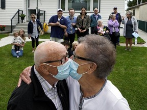 Bill and Barb Donnan share a kiss in the front yard of their Edmonton home on their 60th wedding anniversary, as friends and family gathered to celebrate. Bill (85-years-old) and Barb (79-years-old) were married in Edmonton on May 20, 1960.